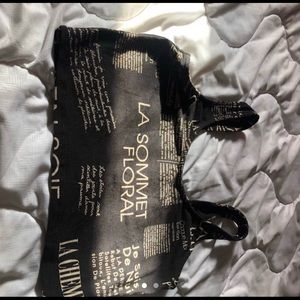 Black newspaper crop top with golden letters